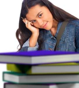 Young Student With Books At School