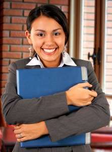 Smiling Asian Girl Carrying A Laptop In A Restaurant